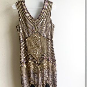 Black and gold sequin dress with fringe trimmings.